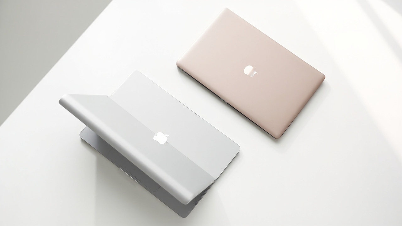 Two lightweight laptops side by side on a desk