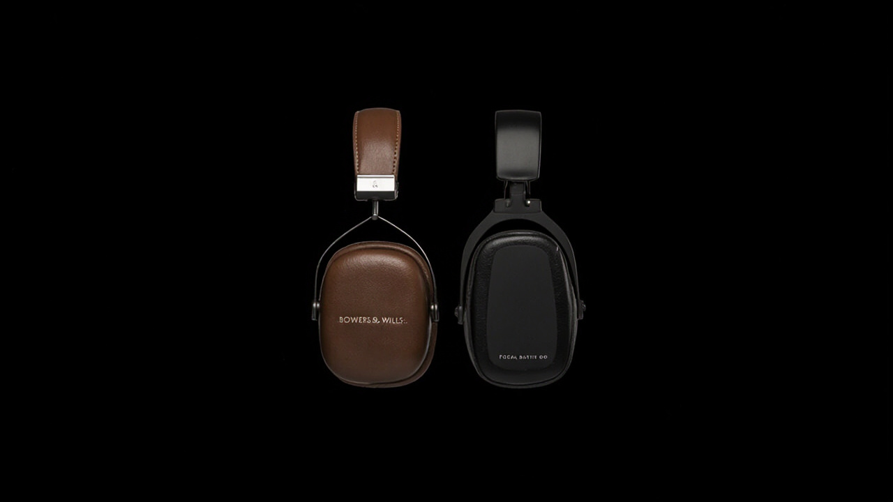 Bowers & Wilkins Px8 S2 (left) and Focal Bathys MG (right) on a wood side table with warm late-afternoon light, photographed from the front three-quarter angle