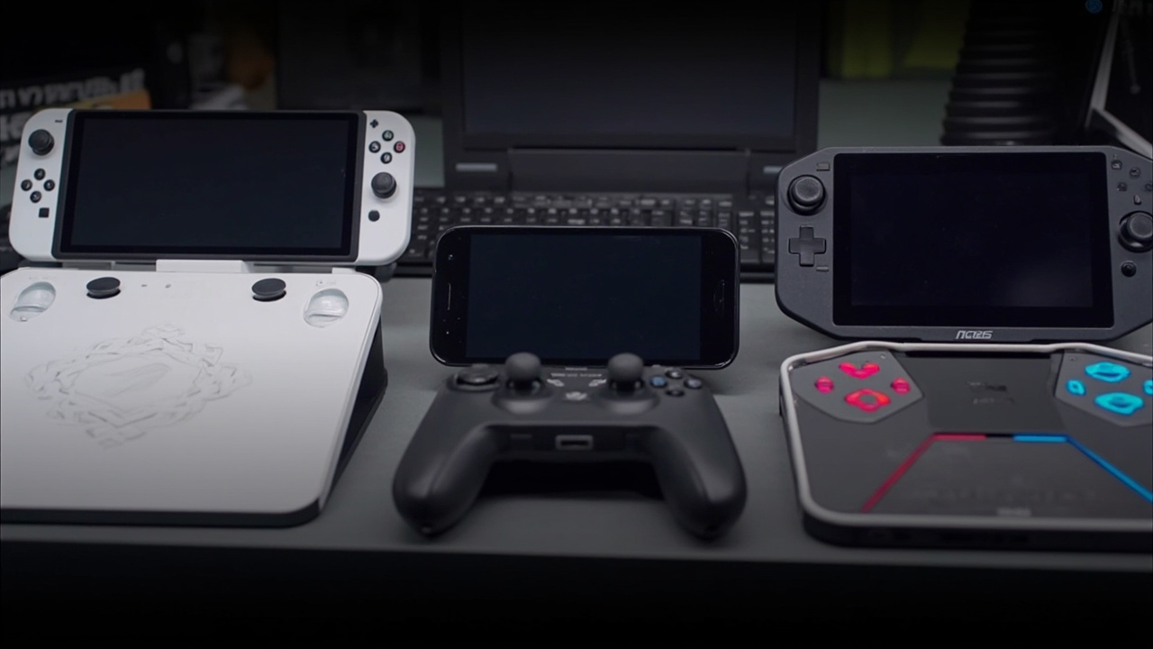 Three handheld gaming PCs arranged side by side on a desk: Steam Deck OLED, ROG Ally X, and Legion Go 2